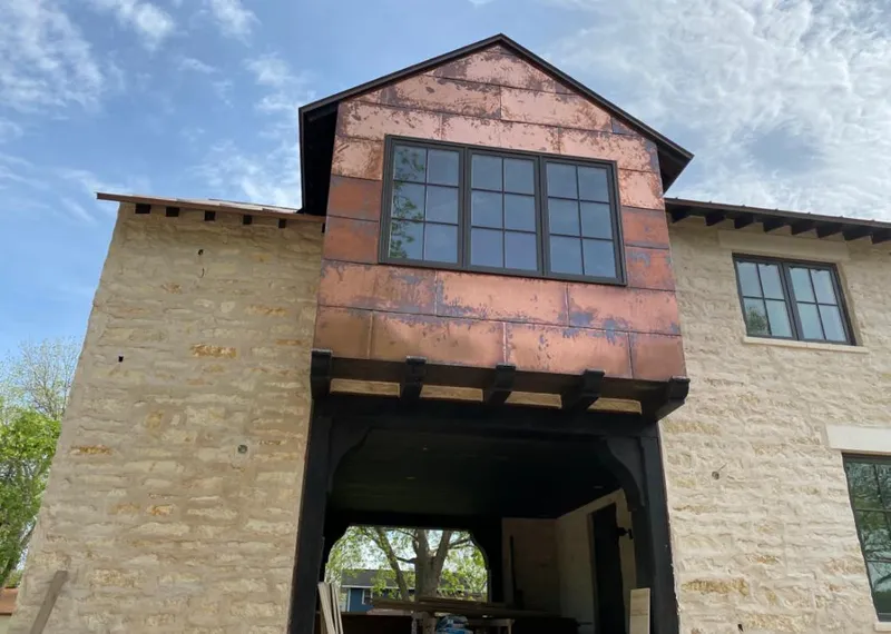 Copper metal panel facade on a stone building for Metal Roof Coating in Homer